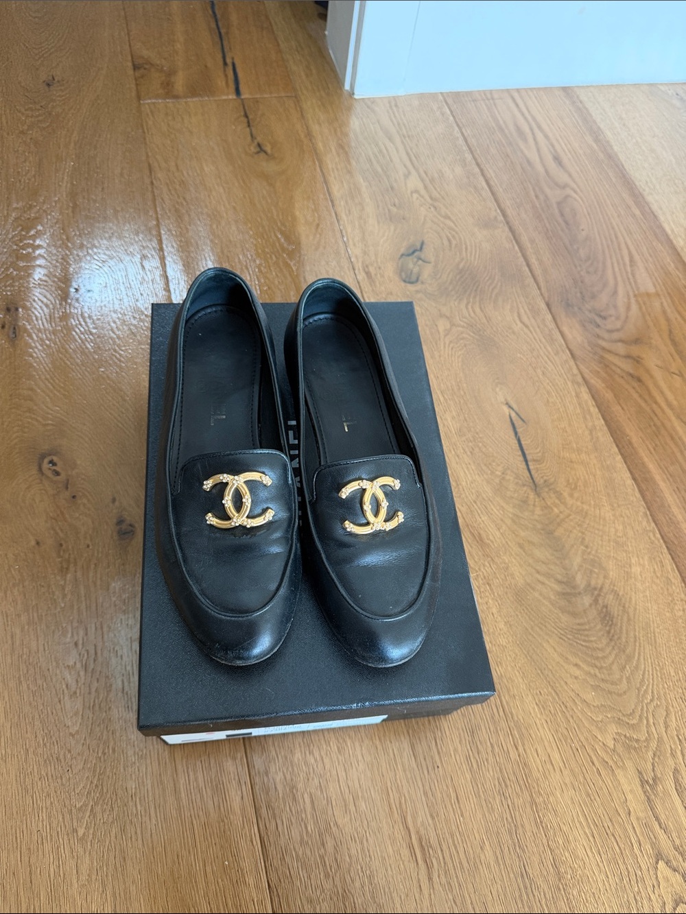CHANEL Black Leather Loafers with Gold CC Emblem